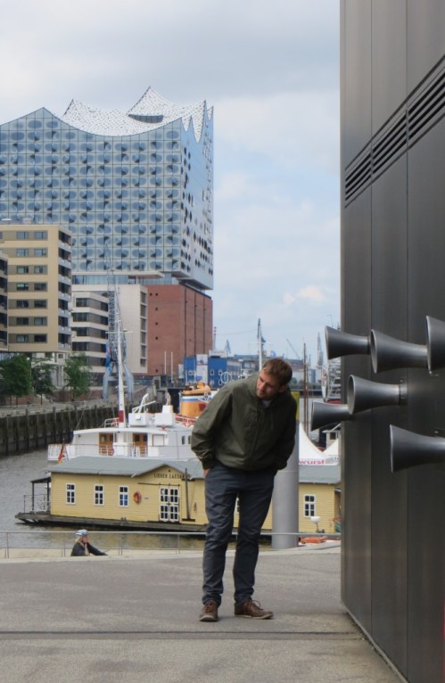 The black building on the right houses a model of the new Elbphilharmonie, an amazingly technically advanced concert hall that is visible in the background.  Recordings are played through the ear trumpets on the wall of the model.